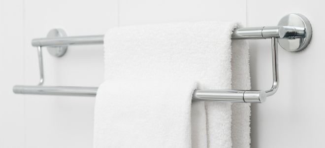 towel bar hanging on wall with two towels