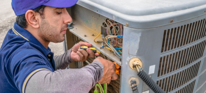 worker installing AC electronics