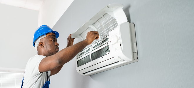 worker installing split air conditioner