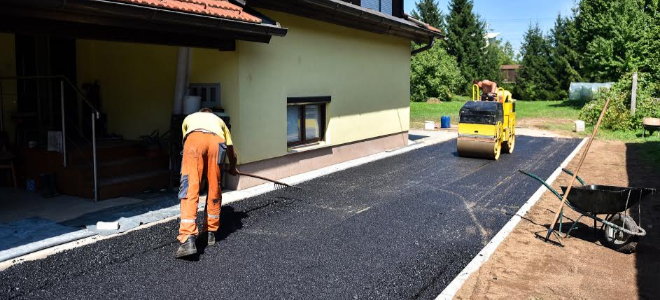 workers laying asphalt surface