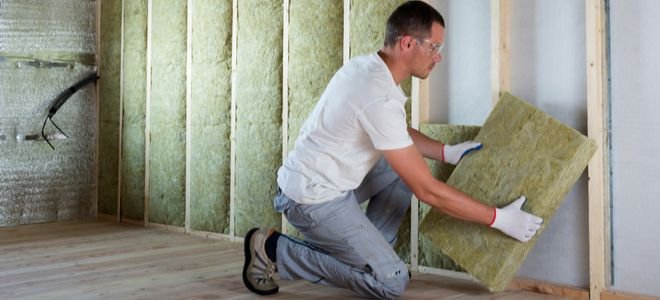 man installing insulation
