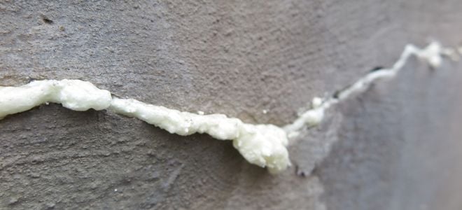 crack in a cement wall filled with insulating foam