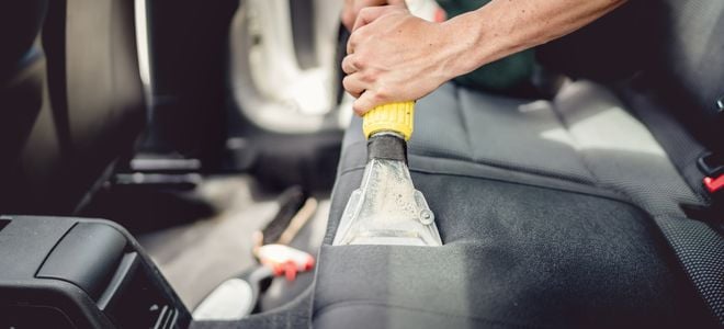vacuuming the interior of a car