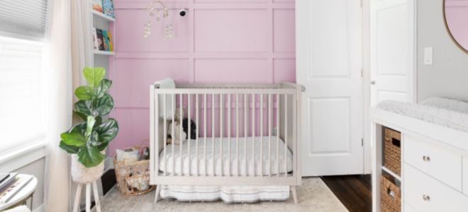 baby's room with pink board and batten walls