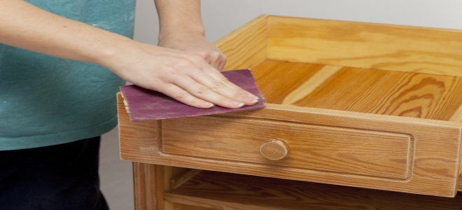 sanding a varnished side table