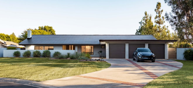 house with Tesla solar tiles and car