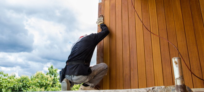 worker replacing wood exterior siding