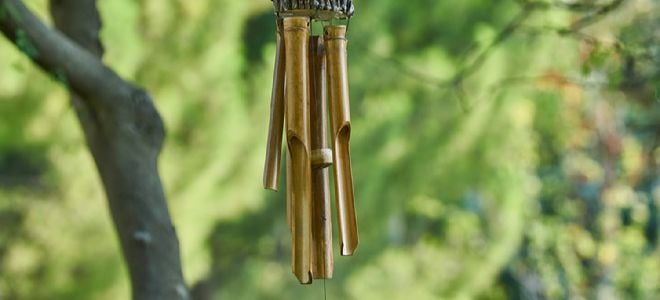 wooden windchime hanging from a tree