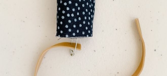homemade scrunchie attached to rubber band with safety pin
