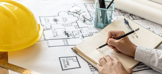 person working on home design blueprints