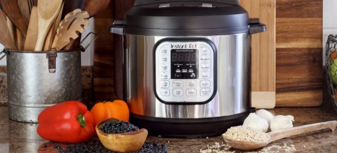 InstantPot cooking machine on counter with wood cutting boards