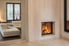 A room with a glass fireplace cover.