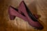 A pair of wine-colored, suede high heels.