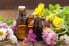 Amber glass bottles surrounded by flowers. 