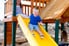 A kid going down a slide on playground equipment