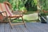 Chair on decking with landscaped yard in the background