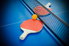 paddle and ball laying near net on ping pong table