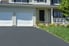 asphalt driveway in front of a house