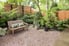 Outdoor sitting area with plants and privacy fence