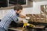 man installing or removing metal backsplash in kitchen