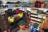 A cluttered mess takes over the space inside a garage.