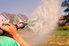 person spraying hydroseed mixture from hose
