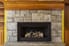 A stone fireplace with an insert.