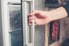 Opening the door of an upright freezer