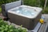 hot tub on a small deck with cover off