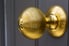 shiny brass doorknob with concentric circles