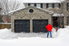 A homeowner shovels snow from his driveway.
