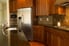Kitchen with dark cabinets and stainless steel appliances.