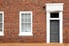 brick building with windows and exterior black door