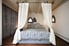 Twin canopy bed with blue comforter