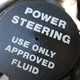 A close-up image of the power steering fluid compartment. 