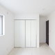 white closet doors and large window in an empty room