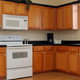 refinished kitchen cabinets with white appliances
