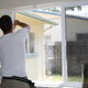 A man installs window film.