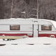 An RV with snow around it.