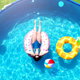 woman on float in above ground pool on grass