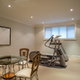 basement room with exercise machine and table