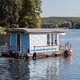 a blue houseboat on the water