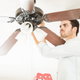 man repairing ceiling fan
