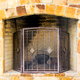 A limestone fireplace with an iron hearth.