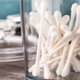 Cotton swabs in a jar on a countertop.