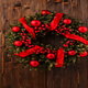 A Christmas wreath with red accents.
