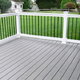clean composite vinyl deck with railing in backyard