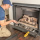 man installing a gas fireplace connection