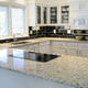 White kitchen with granite countertops