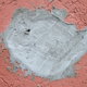a hole in a pink stucco wall